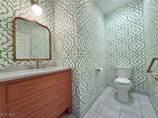 bathroom with tile patterned floors, vanity, and toilet