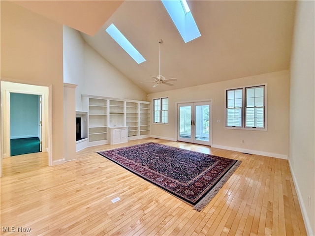 unfurnished living room featuring ceiling fan, high vaulted ceiling, and light hardwood / wood-style floors