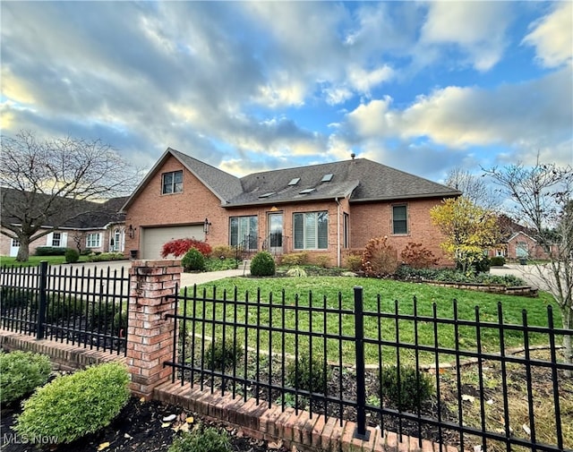 view of front of home with a front yard and a garage