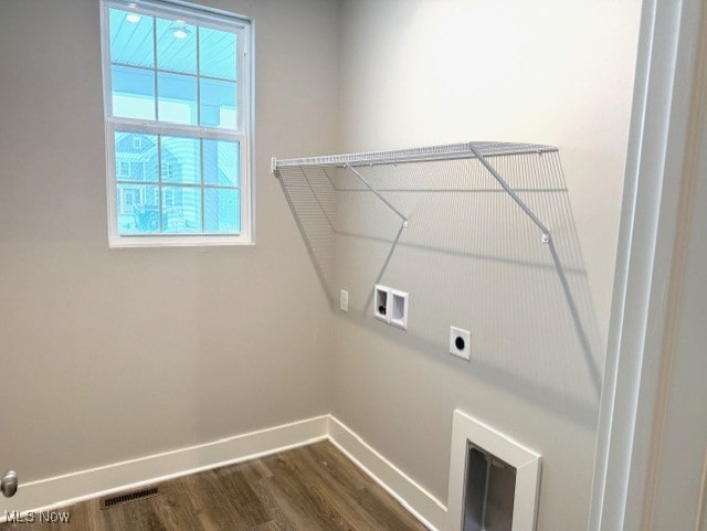 laundry area featuring dark wood-type flooring, hookup for an electric dryer, and hookup for a washing machine