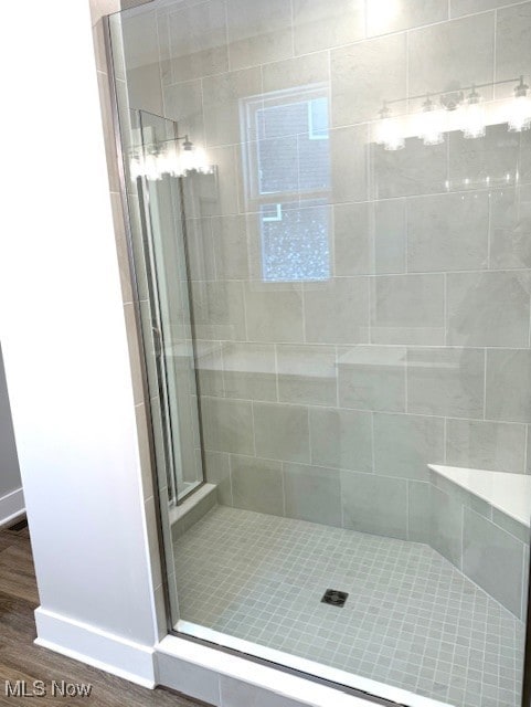 bathroom featuring an enclosed shower and hardwood / wood-style floors