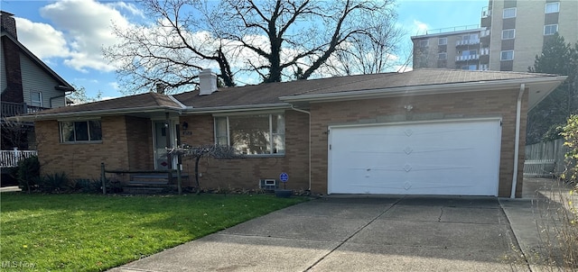 single story home featuring a garage and a front lawn