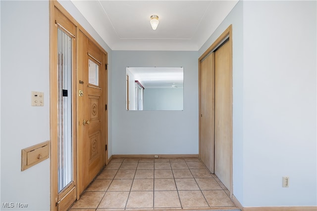 hall featuring light tile patterned floors