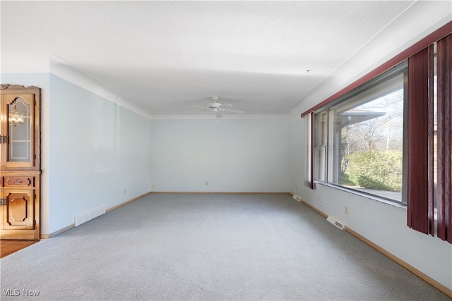 carpeted empty room featuring ceiling fan