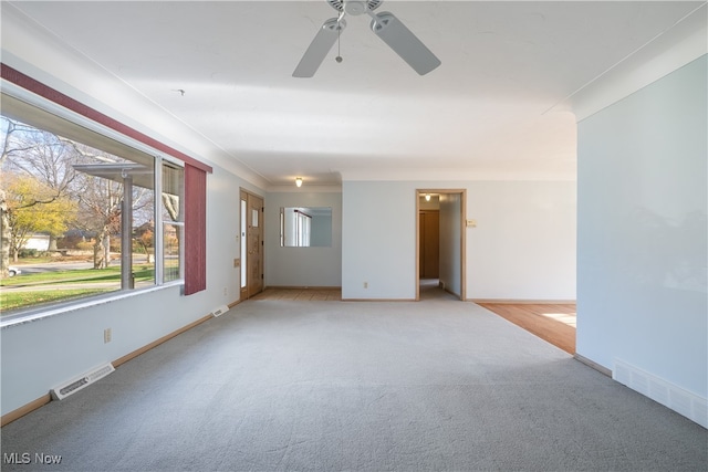 unfurnished room with ceiling fan and light colored carpet