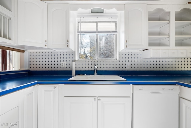 kitchen featuring white cabinets, backsplash, white dishwasher, and sink