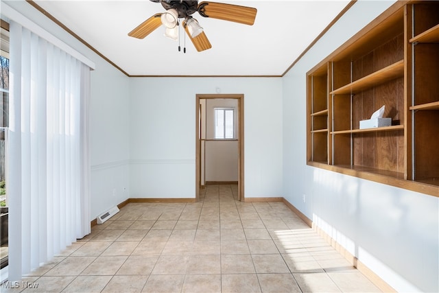 spare room with ceiling fan, light tile patterned flooring, and ornamental molding