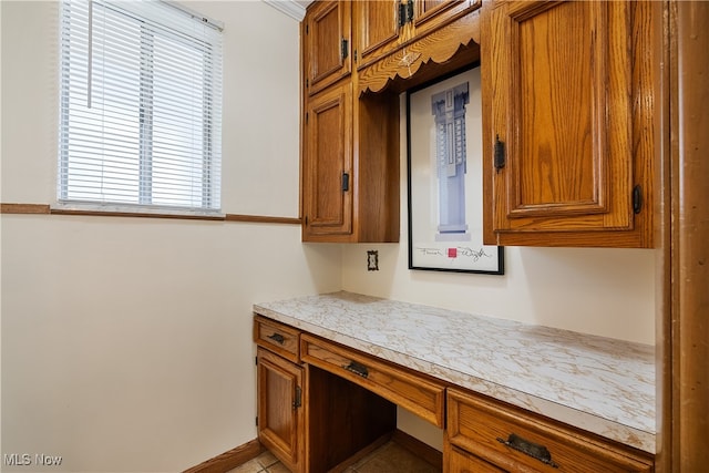 kitchen with built in desk and plenty of natural light