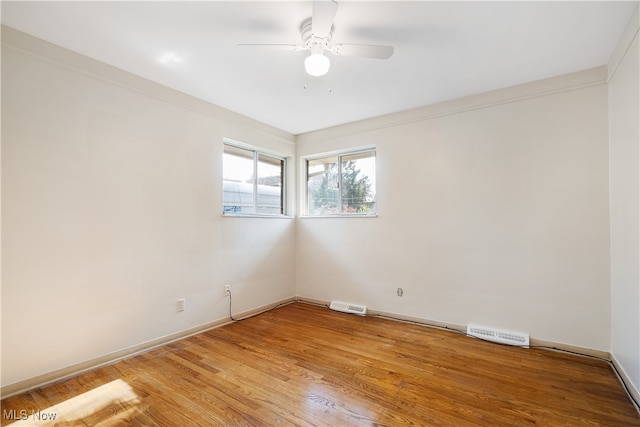 unfurnished room with light wood-type flooring, ceiling fan, and ornamental molding