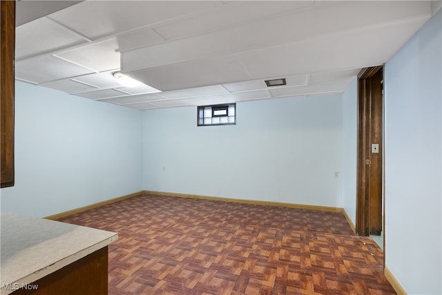 basement featuring dark parquet flooring