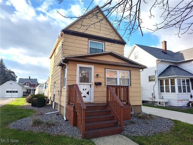 975 Broad St, Conneaut, OH 44030 - view of front of house with an outbuilding and a front lawn
