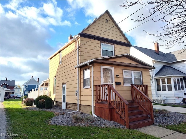 975 Broad St, Conneaut, OH 44030 - view of front of property with a chimney and a front lawn