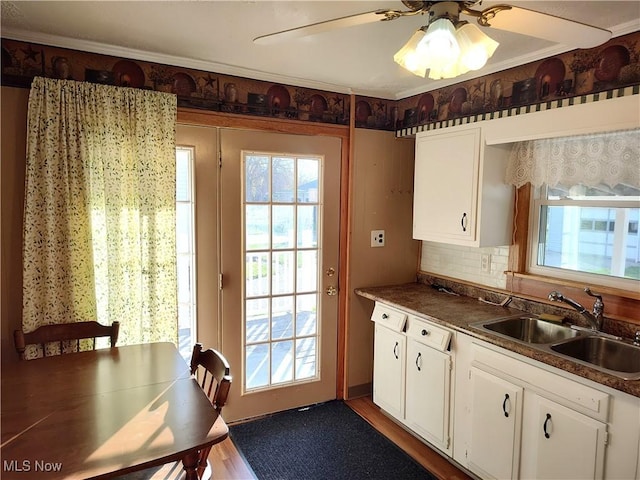 975 Broad St, Conneaut, OH 44030 - kitchen with white cabinets, a ceiling fan, and dark countertops