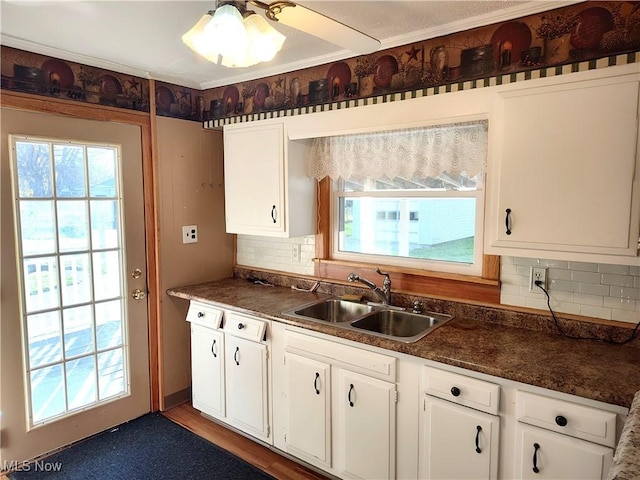 975 Broad St, Conneaut, OH 44030 - kitchen featuring dark countertops, decorative backsplash, and plenty of natural light