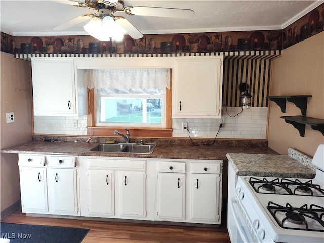 975 Broad St, Conneaut, OH 44030 - kitchen with white range with gas cooktop, white cabinetry, and decorative backsplash