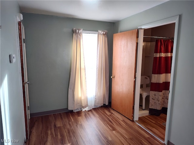 unfurnished bedroom featuring hardwood / wood-style flooring and a closet