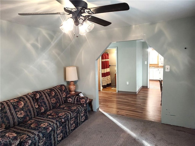 975 Broad St, Conneaut, OH 44030 - carpeted living area featuring a ceiling fan and wood finished floors