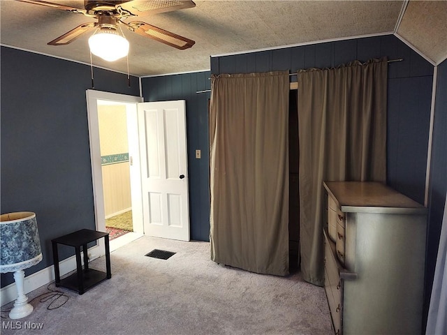 975 Broad St, Conneaut, OH 44030 - bedroom with carpet flooring, ceiling fan, and wood walls
