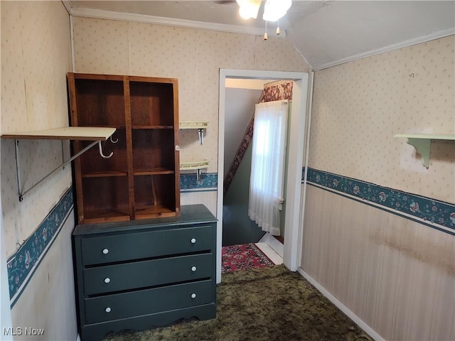 975 Broad St, Conneaut, OH 44030 - unfurnished bedroom with wallpapered walls, ornamental molding, vaulted ceiling, and dark carpet