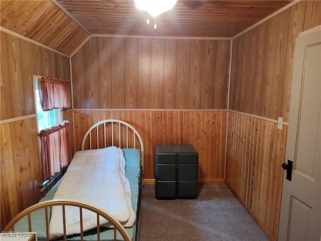 unfurnished bedroom with lofted ceiling, carpet floors, wooden walls, and wooden ceiling