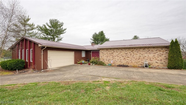 view of front of property with a garage and a front yard