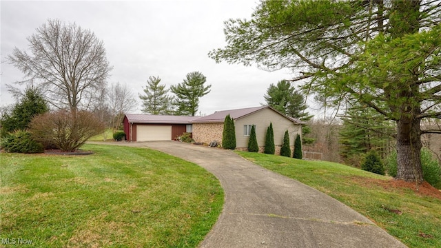 view of front of property with a garage and a front yard