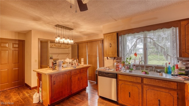 kitchen featuring dark wood-type flooring, sink, hanging light fixtures, stainless steel dishwasher, and a kitchen island