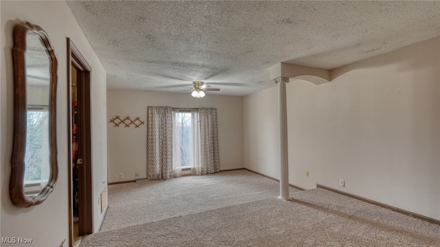 unfurnished room with light carpet, ceiling fan, and a textured ceiling