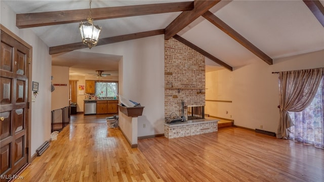 living room featuring vaulted ceiling with beams, light hardwood / wood-style floors, ceiling fan with notable chandelier, and a brick fireplace