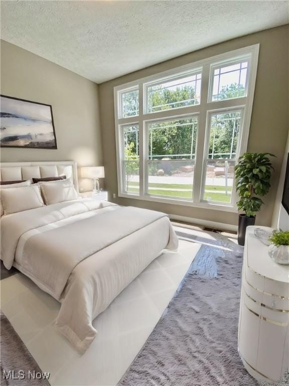 carpeted bedroom with a textured ceiling