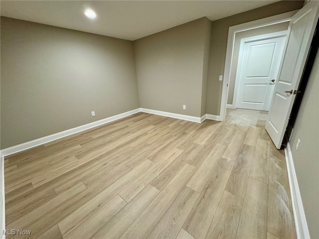 empty room with light hardwood / wood-style floors