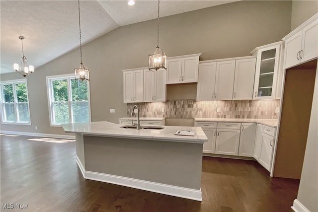 kitchen featuring pendant lighting, a kitchen island with sink, sink, dark hardwood / wood-style floors, and white cabinetry