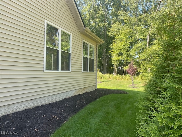 view of side of home with a lawn