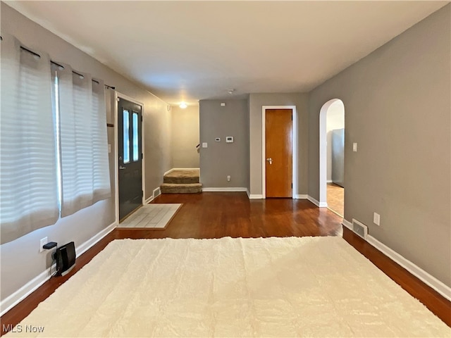 unfurnished bedroom with dark hardwood / wood-style flooring