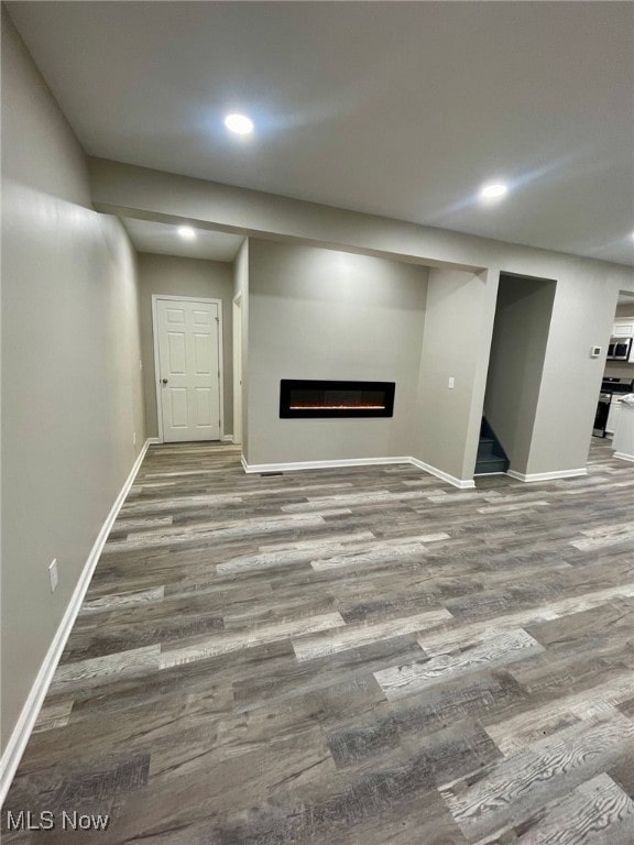 basement with hardwood / wood-style floors