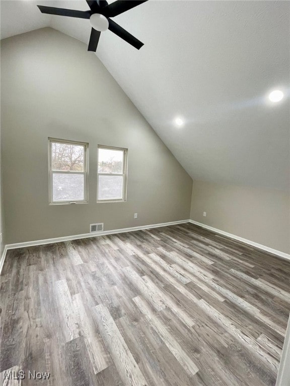 additional living space featuring ceiling fan, lofted ceiling, and hardwood / wood-style flooring