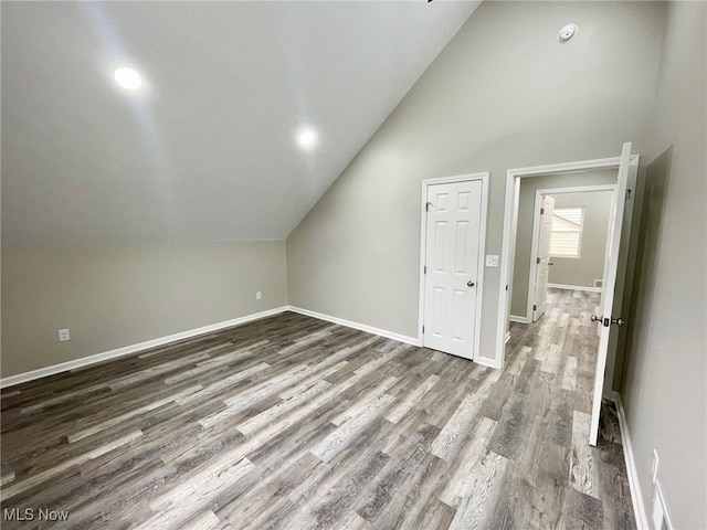 bonus room featuring dark hardwood / wood-style flooring and lofted ceiling