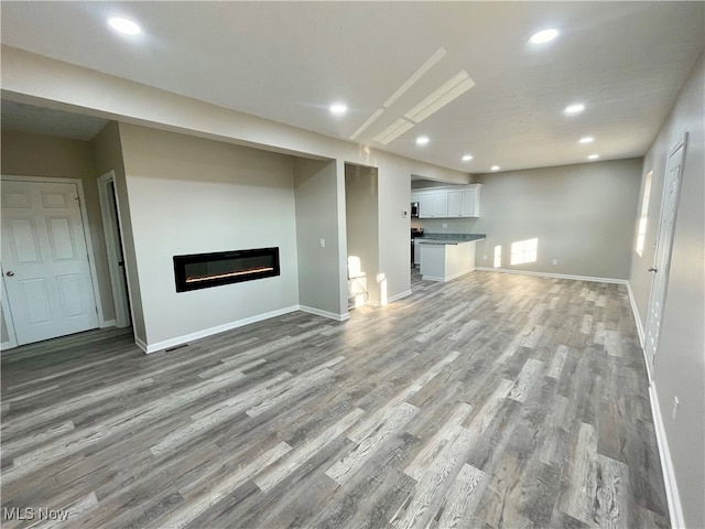 unfurnished living room featuring hardwood / wood-style floors