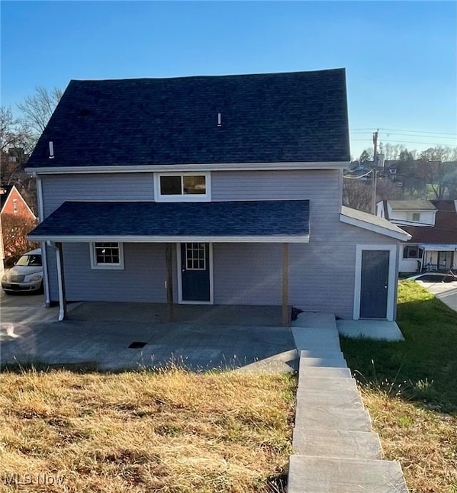 back of house featuring a yard and a patio