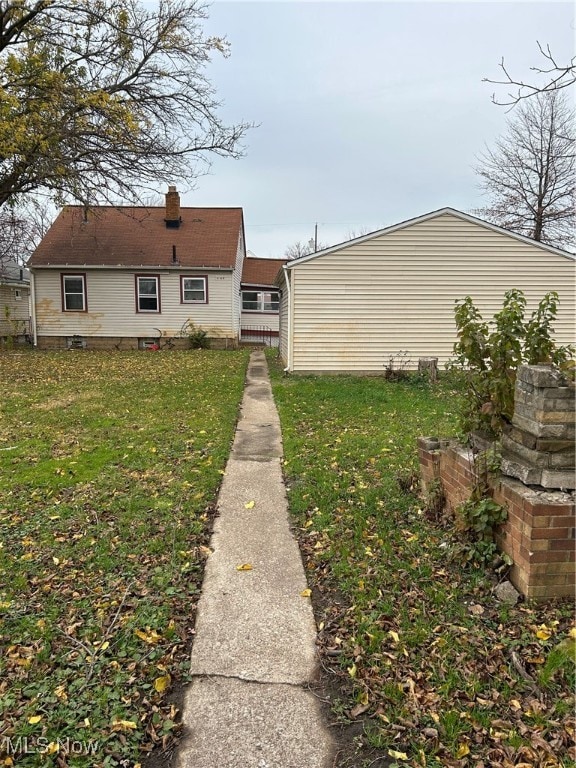 rear view of house with a lawn