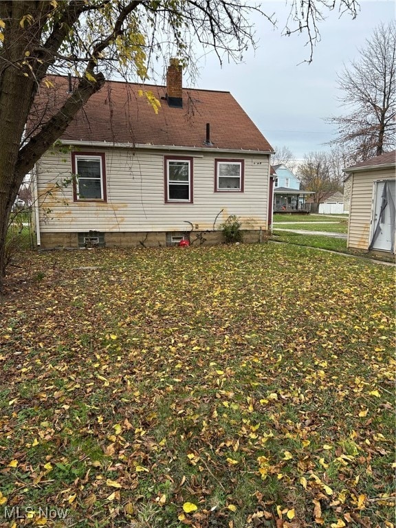 view of side of home with a yard