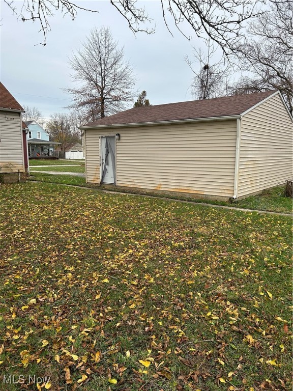 view of outbuilding with a lawn