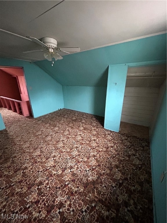 additional living space with ceiling fan, carpet floors, and vaulted ceiling