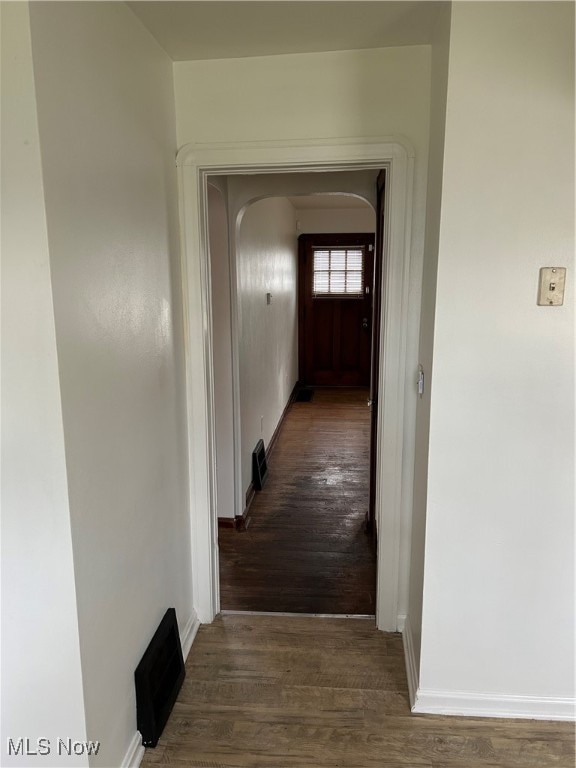 hallway with dark hardwood / wood-style flooring