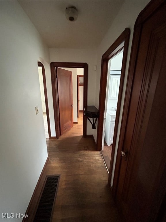 corridor featuring wood-type flooring