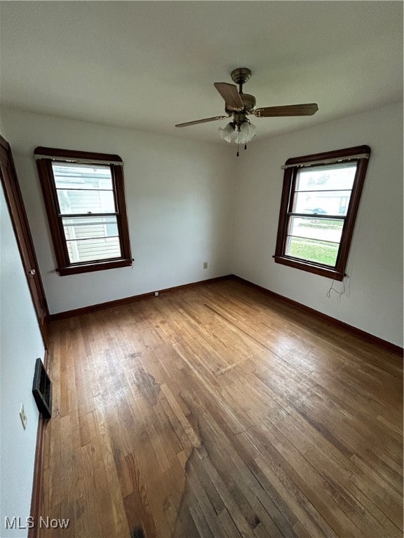 unfurnished room with hardwood / wood-style floors and ceiling fan