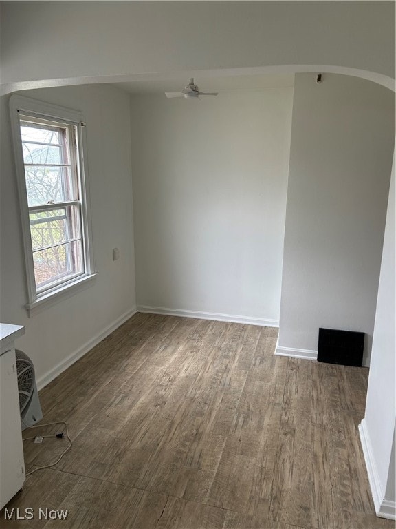 empty room with ceiling fan and hardwood / wood-style floors