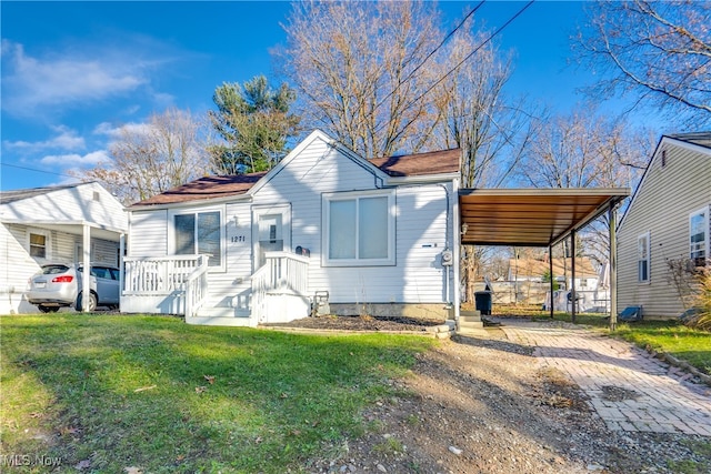 view of front facade with a front yard and a carport