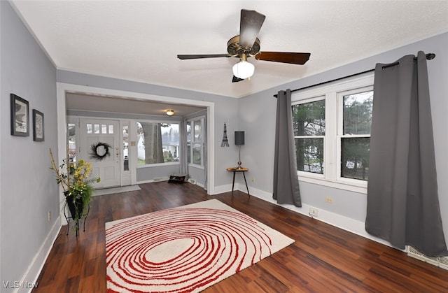 entryway featuring a textured ceiling, dark hardwood / wood-style floors, and ceiling fan