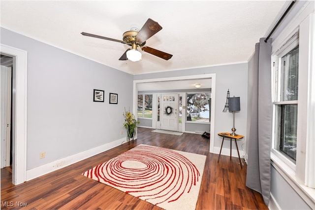 sitting room with a textured ceiling, crown molding, and dark hardwood / wood-style floors